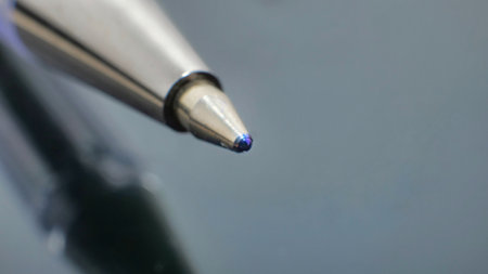 Close-up of ballpoint. Focus on tip. Toned in blueの写真素材