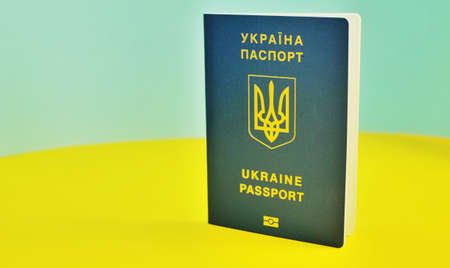 Ukrainian international biometric passport and bag for travel close up.Translation from Ukrainian...