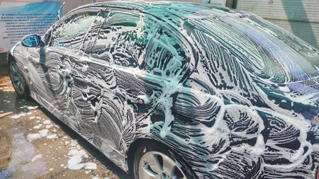 Outdoor car wash with foam soapの写真素材