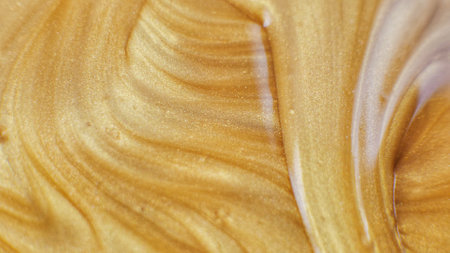 Glitter paint flow. Molten gold texture. Floating ink. Defocused yellow orange sparkling fluid...
