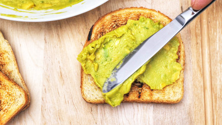 Avocado spread with grated pepper and toasted sliced of bread