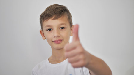 a guy in a white t-shirt. on a white background, raises a finger up
