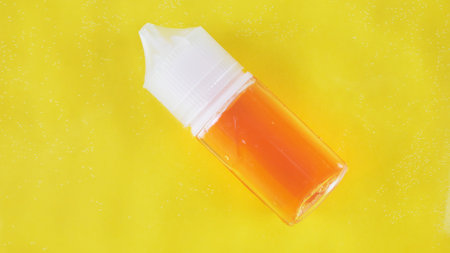Bottle serum and tube cream balance cosmetic in clean transparent water with sunlight on yellow background, flat lay, top view, copy space.の写真素材