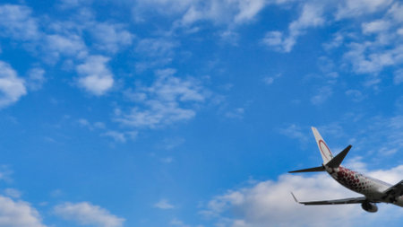 modern airplane tail side view isolated on blue sky part of passenger jet fuselage commercial airplaneの写真素材
