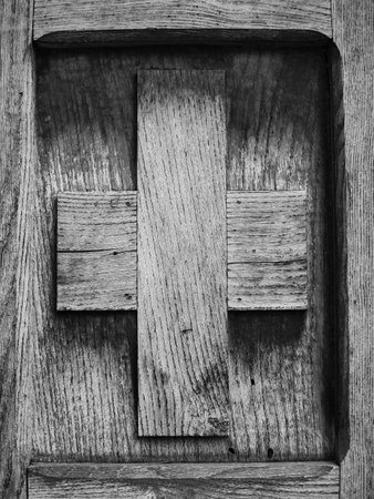 old wooden cross on a wooden doorの写真素材