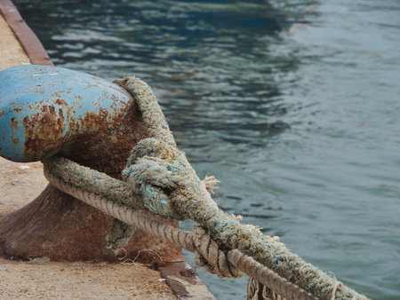 Docking bitte on a wharf. Cast iron terminal with a sailor rope to hook a boatの写真素材