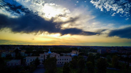 footage taken by drone. bright orange sun sets between architecture related to urban travel, vacation and trafficの写真素材