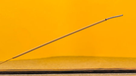 burning incense sticks. incense stick smokes on an orange background