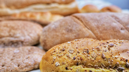 Bread and Bakery Products Isolated on White. Different types of bread: sesame bun, baguette, baked...