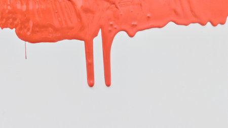 Red paint spreads on a white background. Copy space.の写真素材