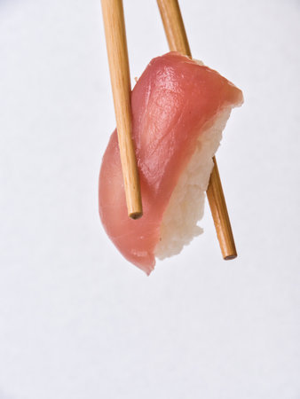 rolls and sushi isolated on white background with gel sticks. Delicious sushi roll with daily chopsticks on a white backgroundの写真素材
