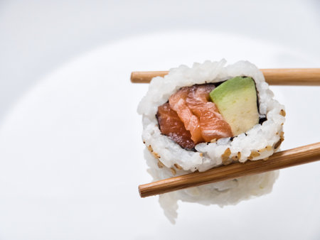 rolls and sushi isolated on white background with gel sticks. Delicious sushi roll with daily chopsticks on a white backgroundの写真素材