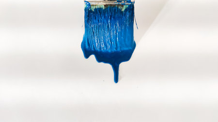 brush with blue paint on a white background