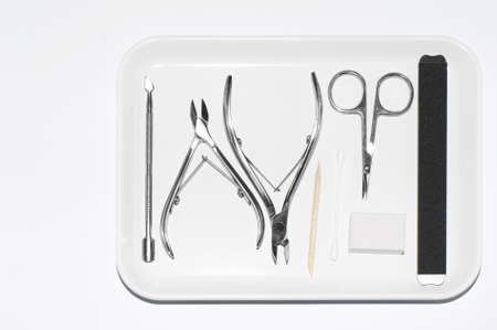 Set of manicure scissors, clipper, spatula, for nail care on a grey background. Professional pedicure equipment for teachers, beauty salons or home use. Manicure on self-isolation. .の写真素材