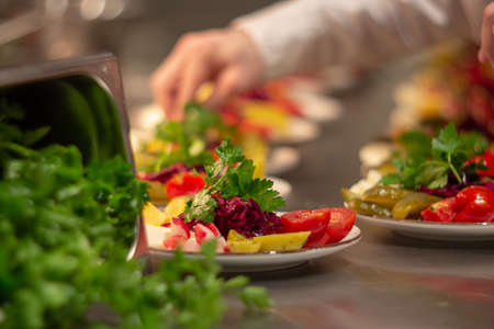 fresh and marinated vegetables salad serving on the platesの写真素材