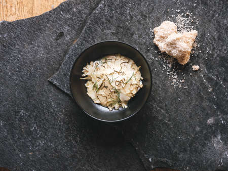 Experimental high gastronomy master piece from chef on the black stone served