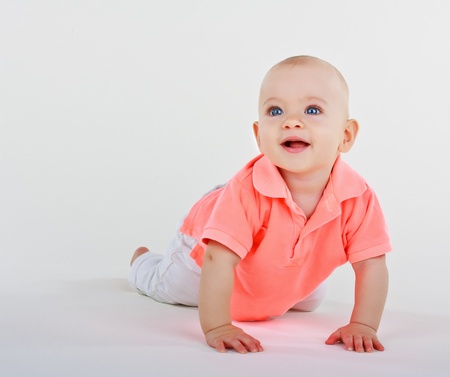 Smiling little boysmiling little boy lying on a white backgroundの写真素材