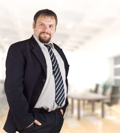 Smiling businessman on the background of of the office.の写真素材