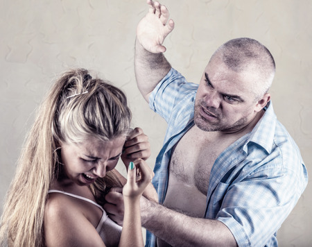 Woman victim of domestic violence and abuse. Husband beats his wifeの写真素材