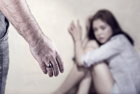 Woman victim of domestic violence and abuse. Focus on handの写真素材