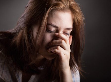 Crying woman on dark background