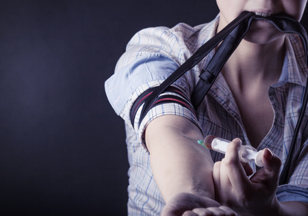 Young woman with drug addictionの写真素材