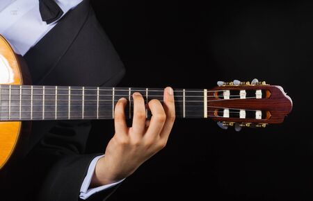Playing the guitar. Musical instrument with performer handsの写真素材