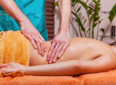 Beautiful woman getting a massage in the spa salonの写真素材