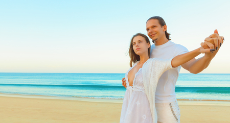 Romantic couple walking on romantic travel honeymoon vacation at the beachの写真素材