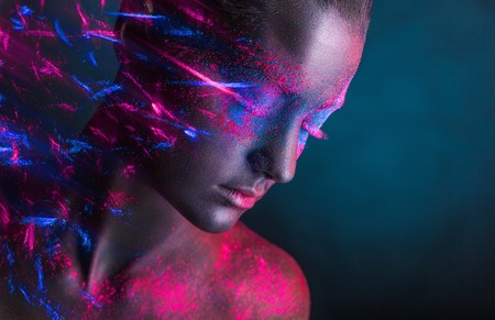 Young woman with black makeup on her face and colored shadowsの写真素材
