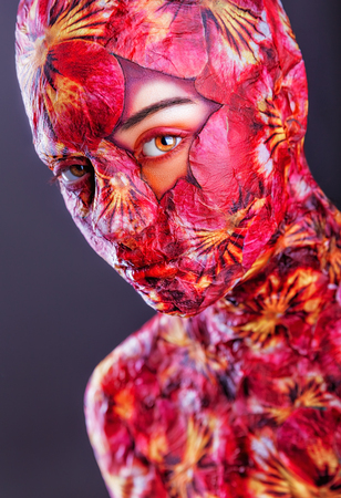 Portrait of beautiful woman model with bright floral makeup on a gray の写真素材