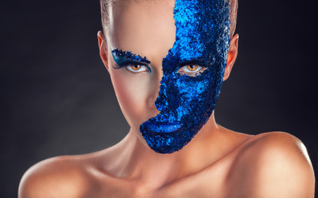 Fashion makeup. Close-up of a young woman with make-up on a dark の写真素材