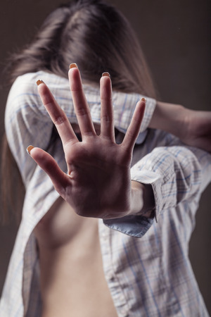 Close up view of young woman making stop gesture with her hand. Focus on the handの写真素材