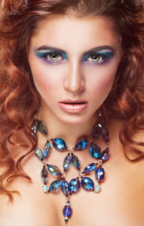 Beautiful young woman with fashion makeup and jewelryの写真素材