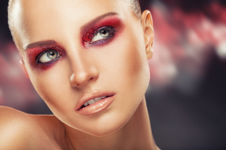 Portrait of a young woman with fashion makeup on a dark backgroundの写真素材