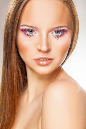 Gentle makeup. Close-up face of a beautiful young woman with fashion make-upの写真素材
