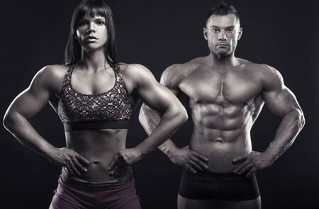 Bodybuilding. Beautiful sports couple of bodybuilders. Sport concept. Black and white imageの写真素材