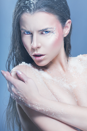 Portrait of young woman with fashion makeup with rhinestone and sea salt. Glamorous makeupの写真素材