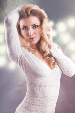 Portrait of a beautiful adult woman with makeup on a light backgroundの写真素材