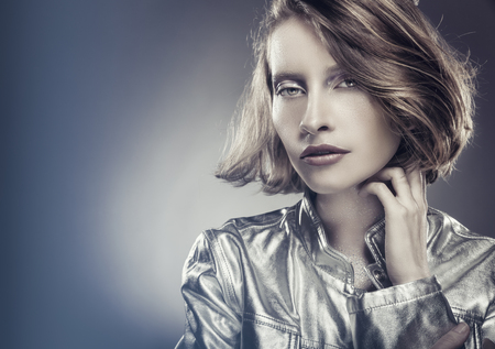 Portrait of a beautiful sexy woman with natural make-up in a silver jacket. Glamour pictureの写真素材