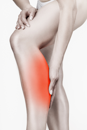 Woman having pain in his leg isolated on white backgroundの写真素材