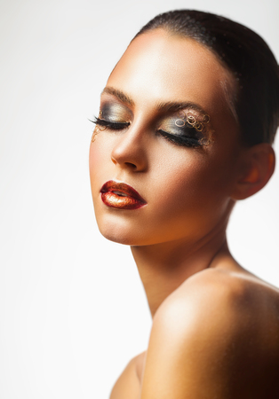 Portrait of a young woman with fashion makeup on a white background. Closed eyesの写真素材