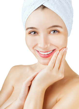 Beautiful young woman's face with a towel on her head isolated on white backgroundの写真素材