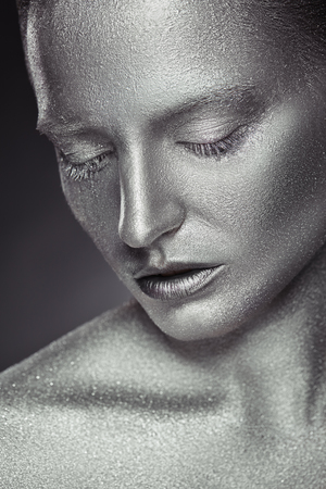 Fashion makeup. Close-up of a young woman with silver makeup with  sequinsの写真素材