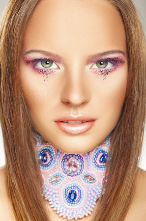 Close-up portrait of a beautiful young woman model with glamor make-up and gorgeous hairの写真素材