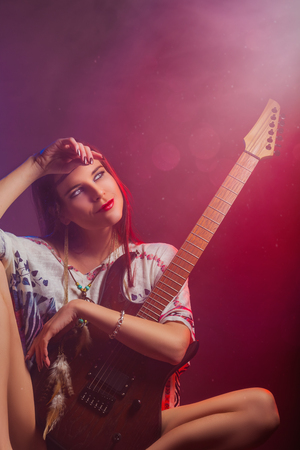 Portrait of a sexy girl with an electric guitar. Beauty and fashion conceptの写真素材