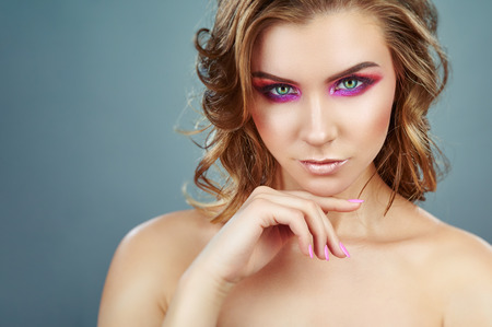 Beauty fashion model girl. Beautiful model girl with pink fuchsia makeup. Fashion makeup and cosmeticsの写真素材