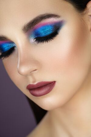 Close-up face of a beautiful sexy fashion woman with closed eyes trendy make-upの写真素材