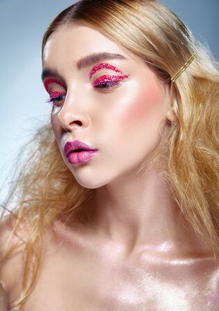 Pin-up or retro girl. Fashion makeup beautiful young woman with curly hairの写真素材