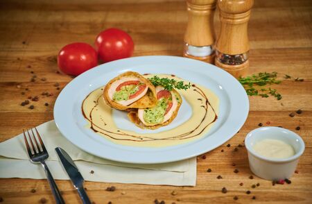 Delicious chicken fillet baked with caprese. Arrangement with cutleryの写真素材